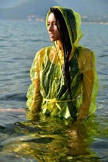 With PVC raincoat in the sea
