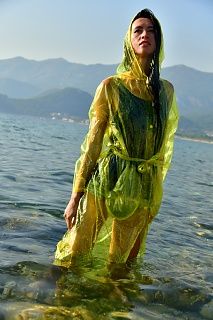 With PVC raincoat in the sea